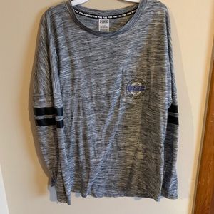 A long sleeve gray shirt with leather around arms.